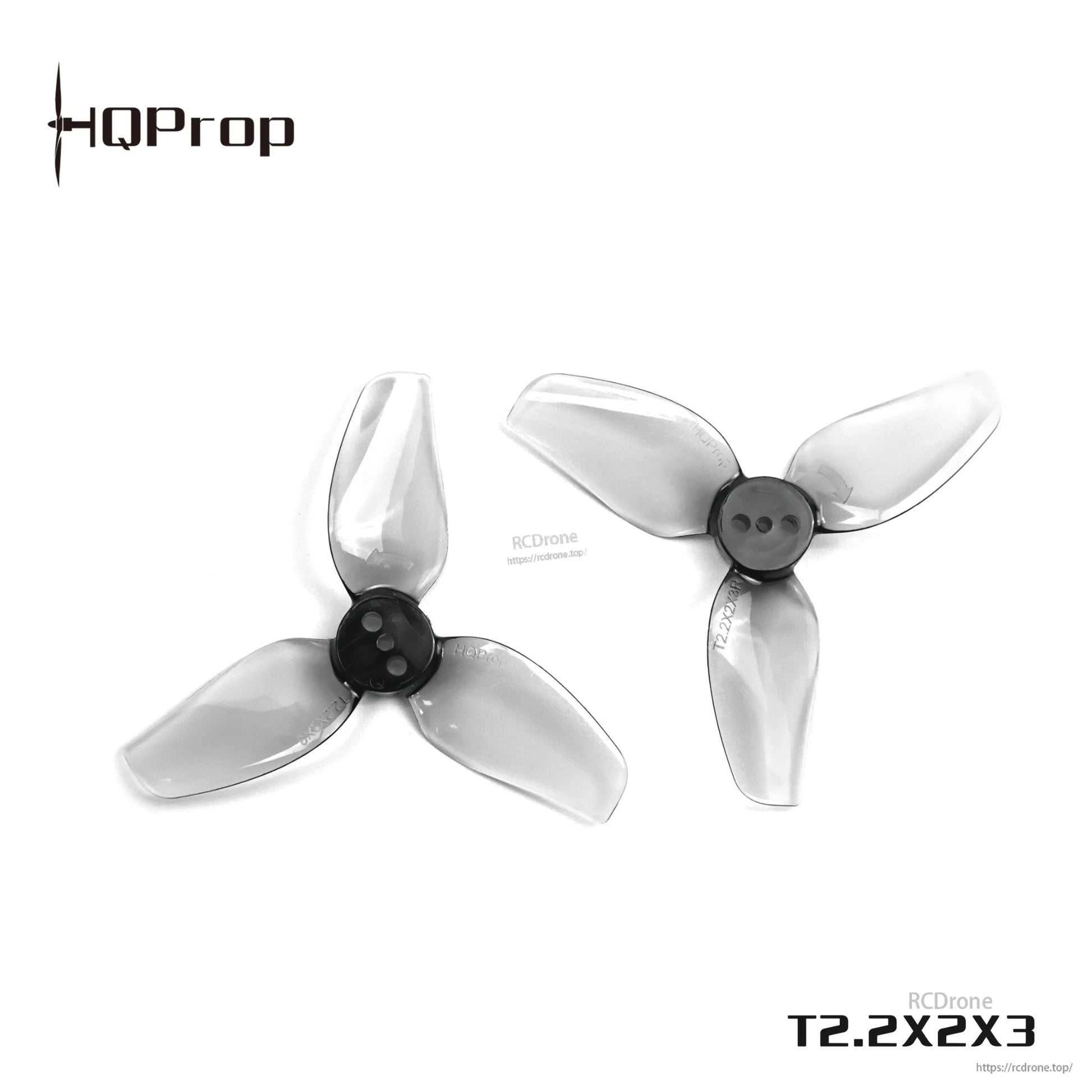 Close-up of pair of grey tri-blade drone propellers showing center hub and mounting holes (T2.2X2X3)