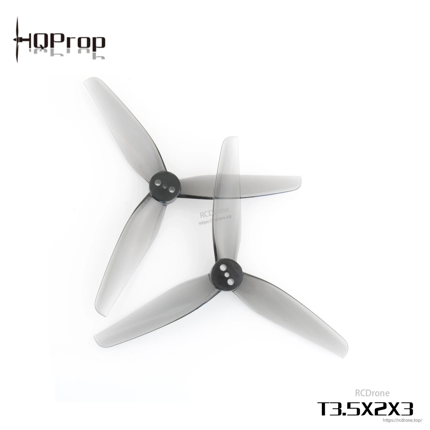 Two grey 3-blade polycarbonate FPV drone propellers with black hubs, top view on white background