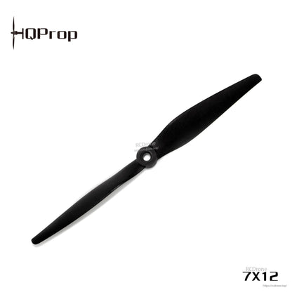 Angled top view of black 7x12 two-blade propeller with center mounting hole on white background