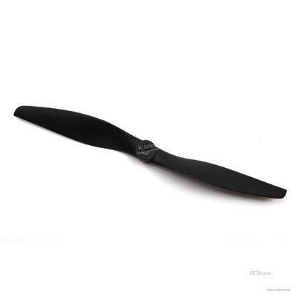 Angled view of black two-blade pusher propeller showing hub face and thin blade profile