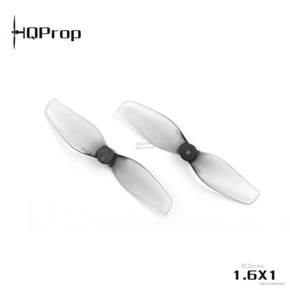 Angled view of two HQProp 1.6x1 grey translucent 40mm whoop props showing 2-blade profile and center hub
