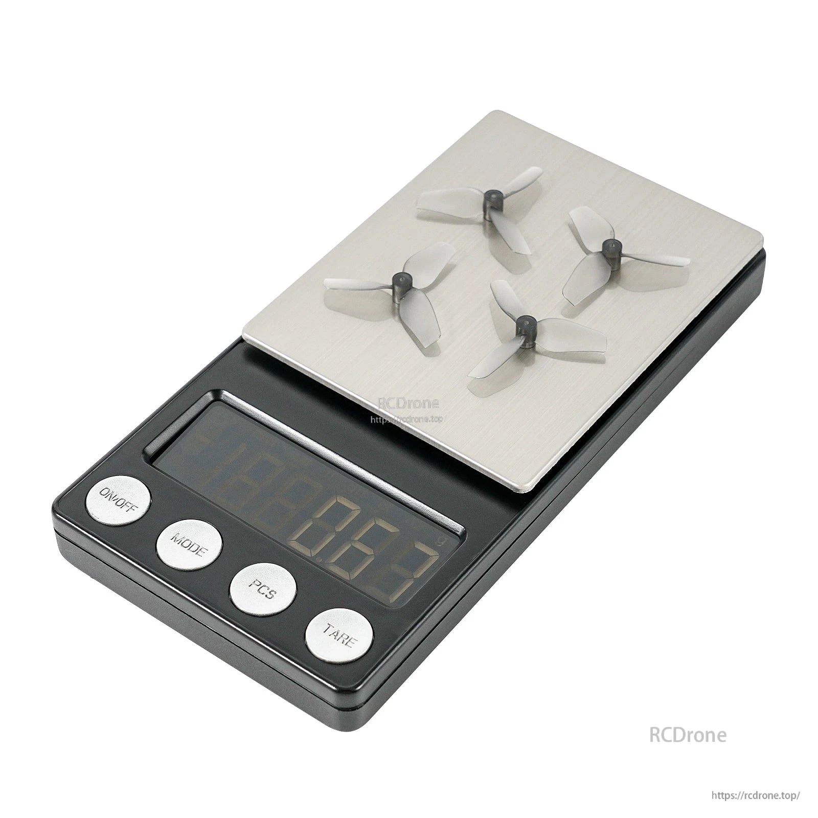 Four 3-blade micro propellers shown on a digital scale for weight reference