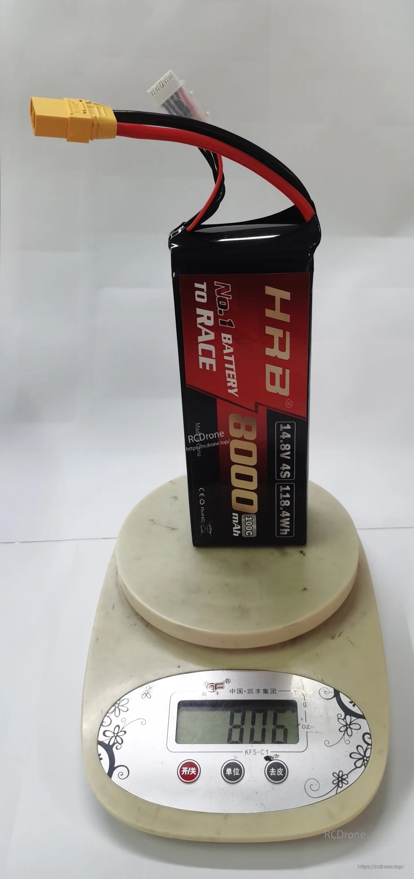 HRB 8000mAh 4S LiPo battery standing upright on a digital scale, with XT90 connector visible