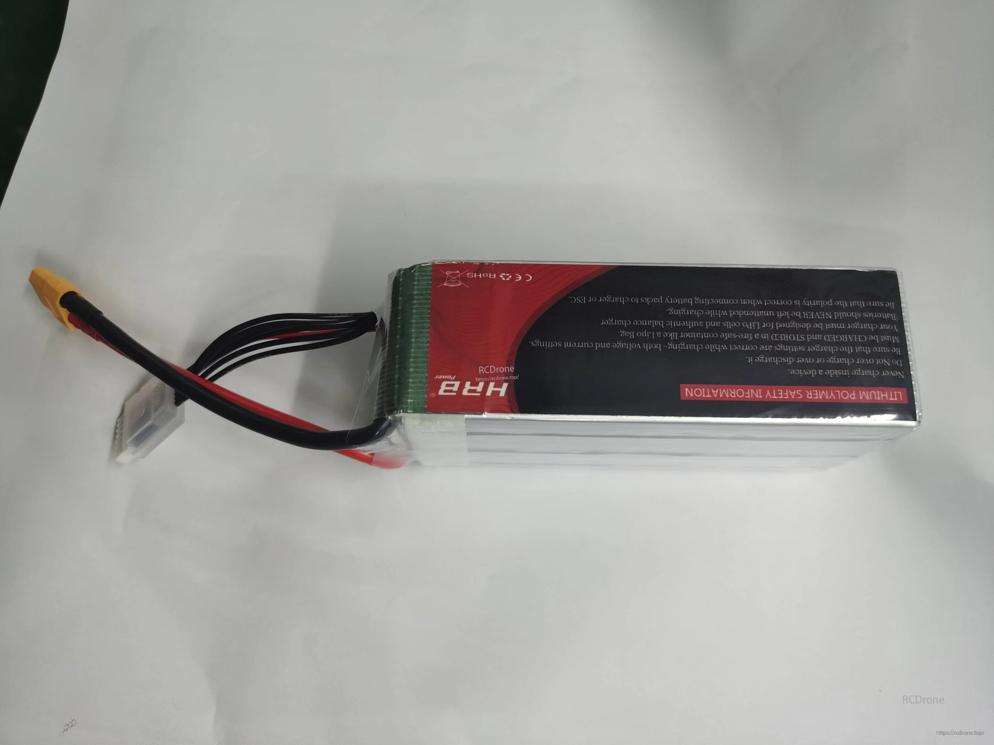 Back side of HRB 6S LiPo battery with safety label, balance lead and yellow discharge connector visible