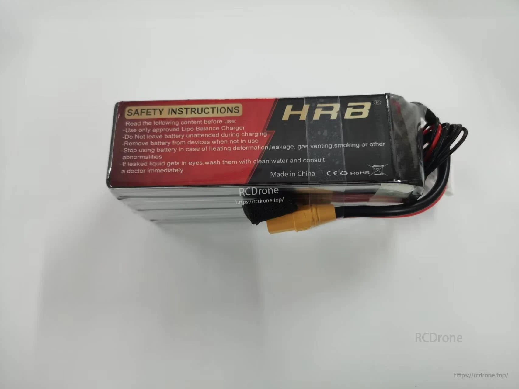 Opposite side view of HRB 6S LiPo battery showing safety instructions label and attached power/balance wires