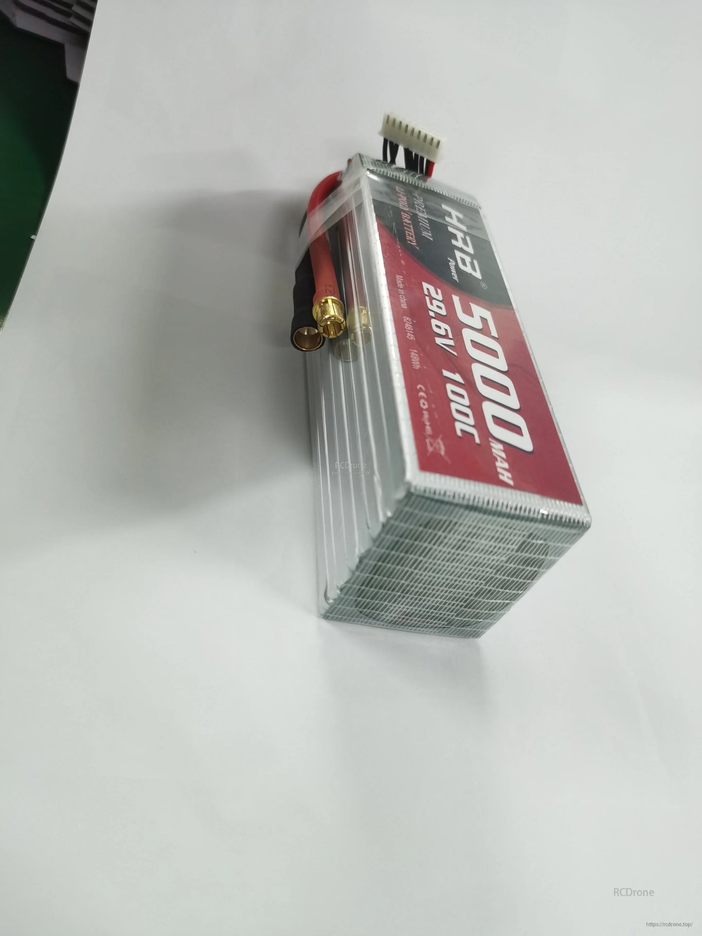 End view of battery pack showing stacked cell edges and bundled leads with yellow main connector