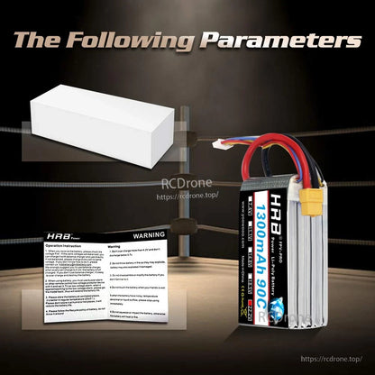Included accessories graphic showing white box and warning leaflet with upright battery on right
