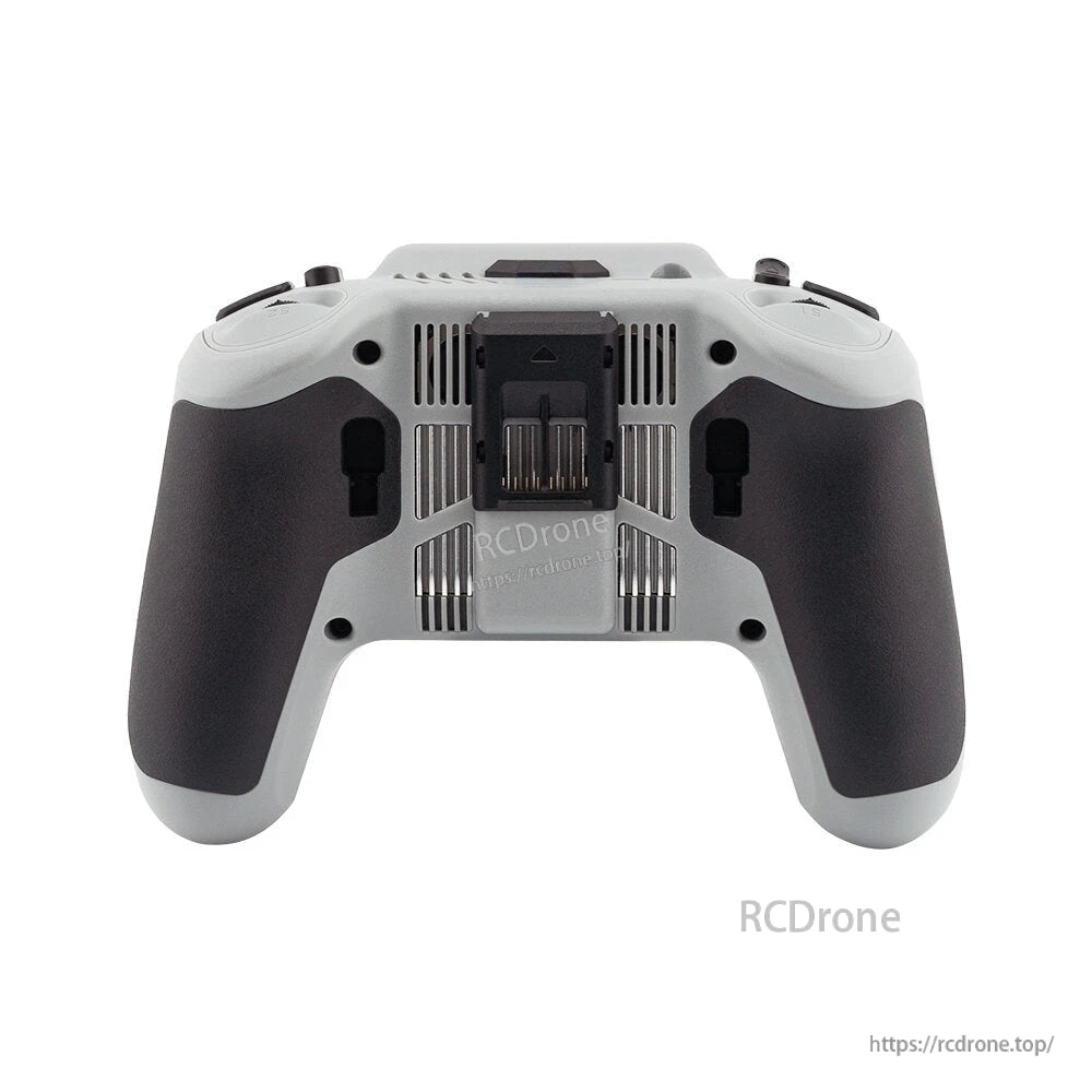 Rear view of transmitter showing back vents, center module bay cover, and textured hand grips