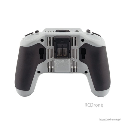 Rear view of transmitter showing back vents, center module bay cover, and textured hand grips