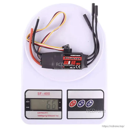 Hobbywing Skywalker 60A V2 ESC with power and motor leads, shown on a digital scale reading 66g