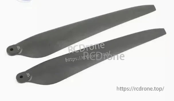 Pair of black drone propeller blades with mounting holes, suitable for agricultural drone propulsion setups