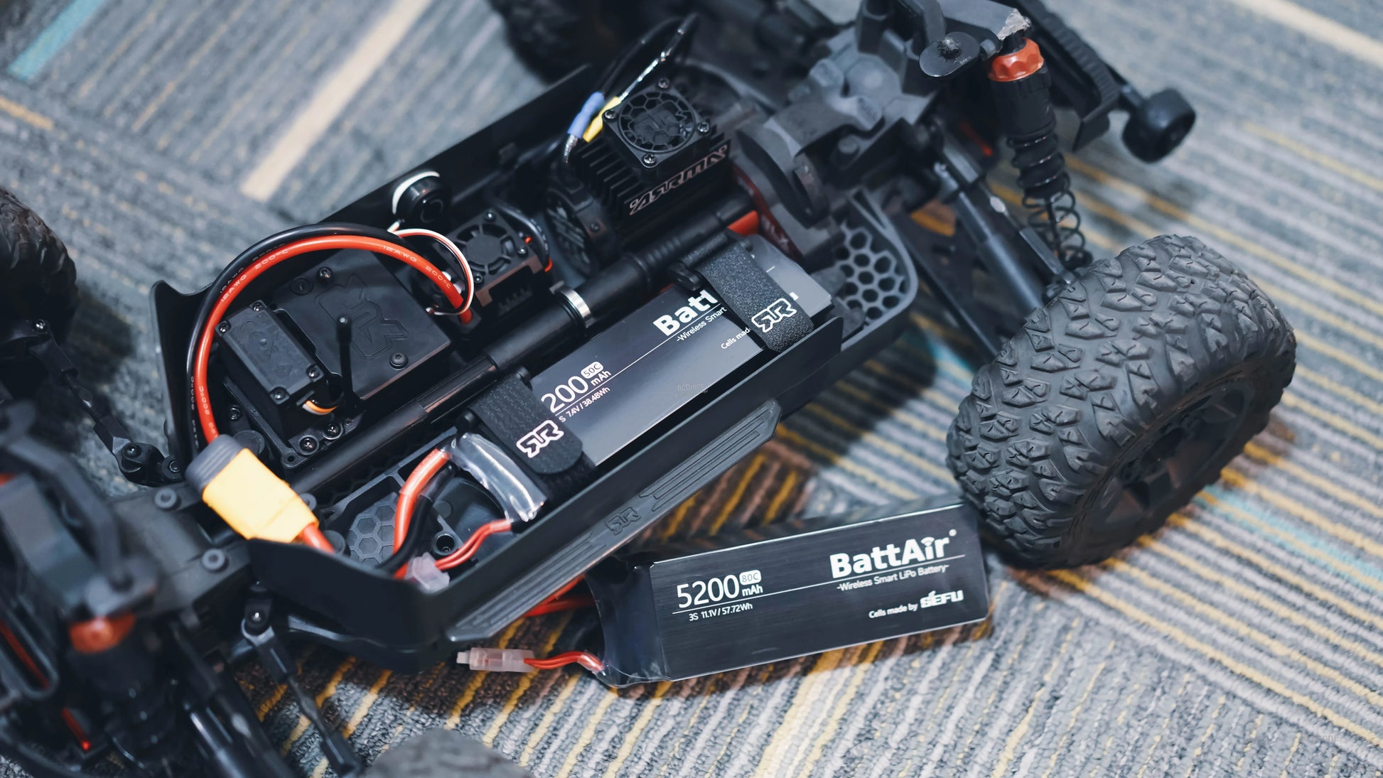 ISDT BattAir smart RC LiPo battery packs (2000mAh and 5200mAh 3S) with XT60 lead in an RC car tray