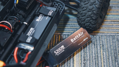 ISDT BattAir smart RC LiPo battery pack labeled 5200mAh, pictured next to an RC car battery tray