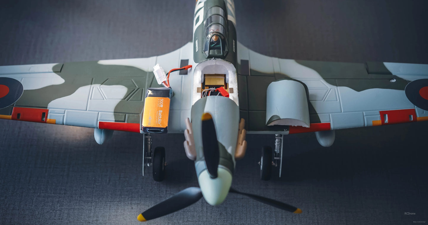 ISDT BattAir smart RC LiPo battery with attached leads and balance plug next to a model airplane
