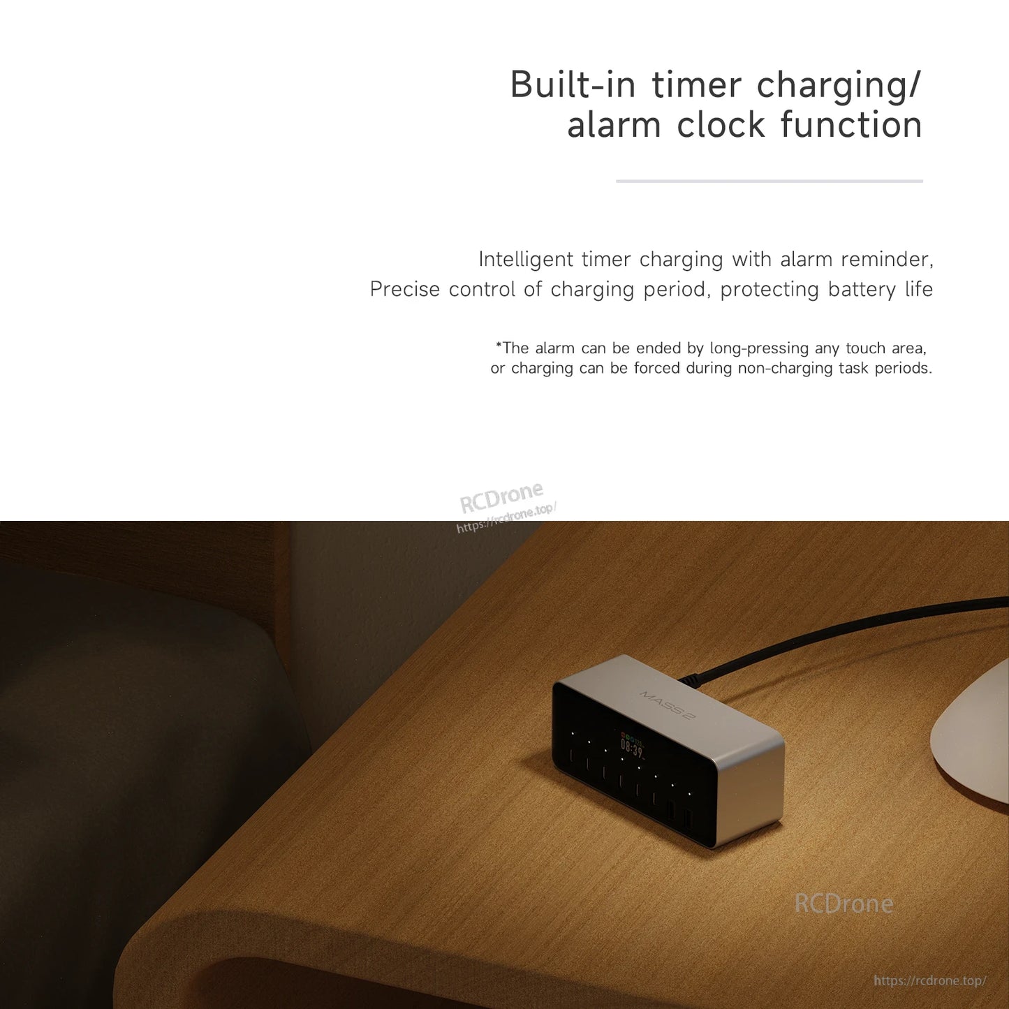 ISDT MASS2 desktop power station on a desk with digital display and built-in timer charging/alarm clock feature text