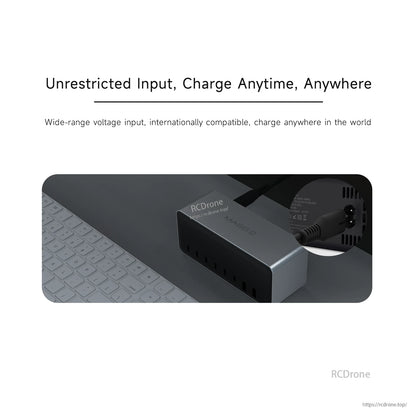 ISDT MASS2 desktop power station on a desk with AC power input connected and multiple front charging ports