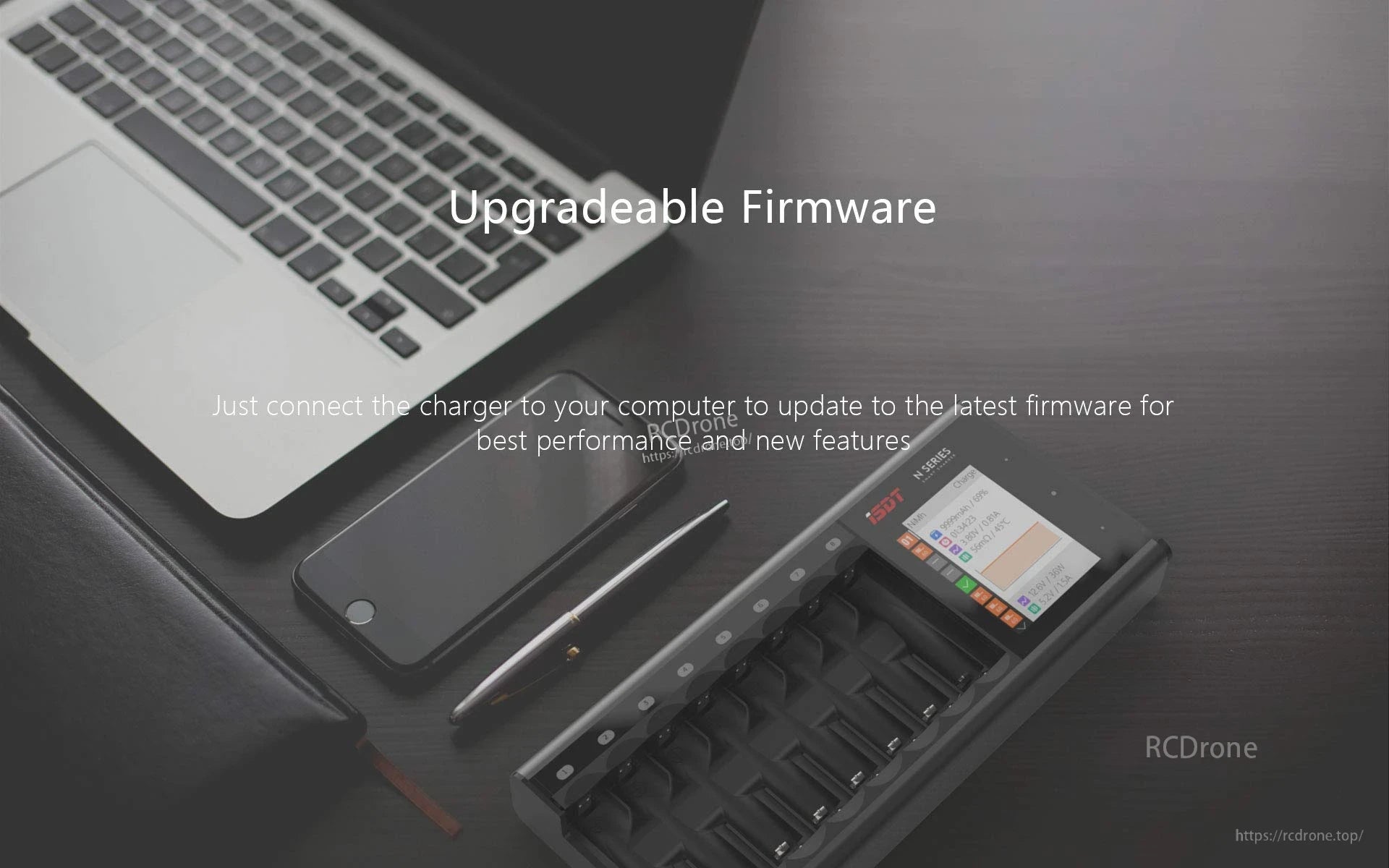 ISDT N16 Battery Charger, ISDT N16 multi-slot battery charger with display screen on a desk beside a laptop, promoting upgradeable firmware
