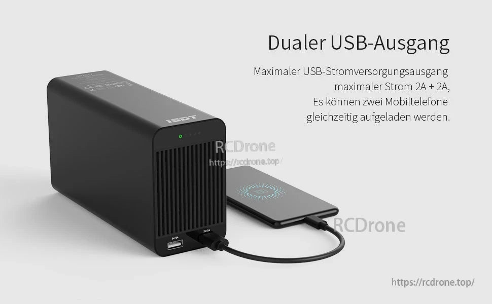 ISDT SP2425 DC power supply with dual USB-A outputs on the front panel, charging a phone