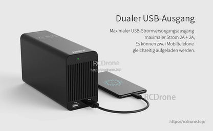 ISDT SP2425 DC power supply with dual USB-A outputs on the front panel, charging a phone