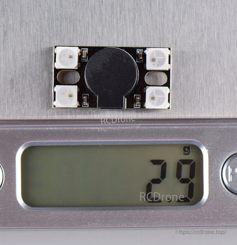 JHEMCU BZ110DB_WS2812 module on digital scale showing approximately 2.9 g installed weight