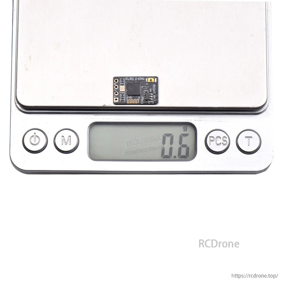 RX24T micro ELRS receiver board on digital scale reading 0.6 g