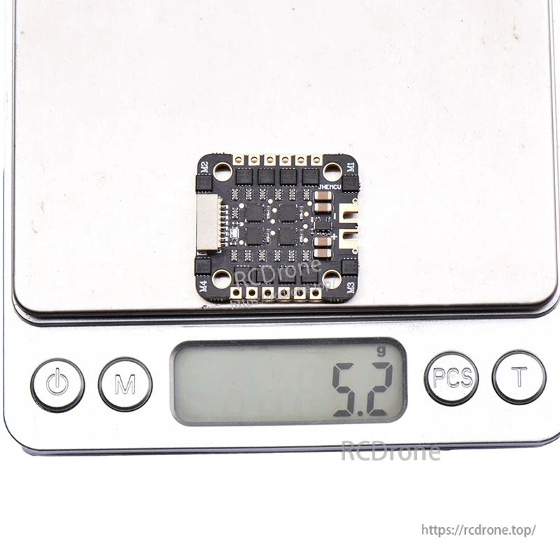 EM-40A 4-in-1 ESC on digital scale indicating approximately 5.2 g weight