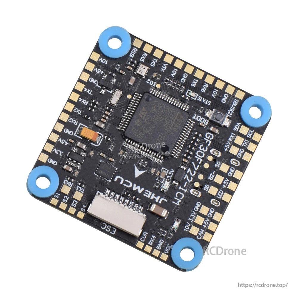Angled view of the GF30F722-ICM flight controller showing JHEMCU branding, pad layout, and corner grommets