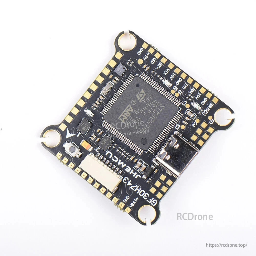 Angled top view of STM32H743 flight controller showing USB-C connector and processor chip