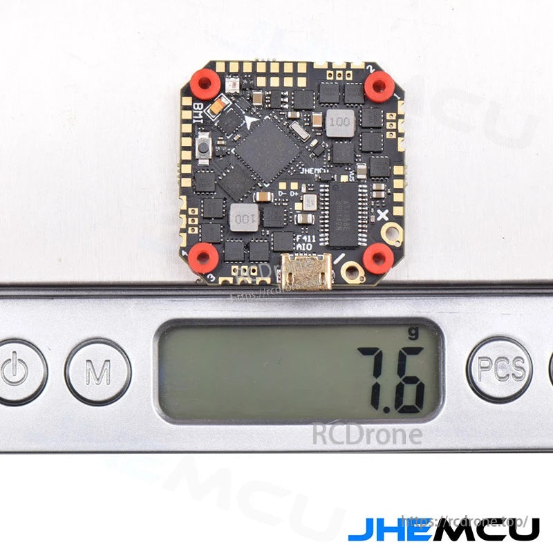 Flight controller on digital scale displaying 7.6g weight for lightweight micro FPV builds