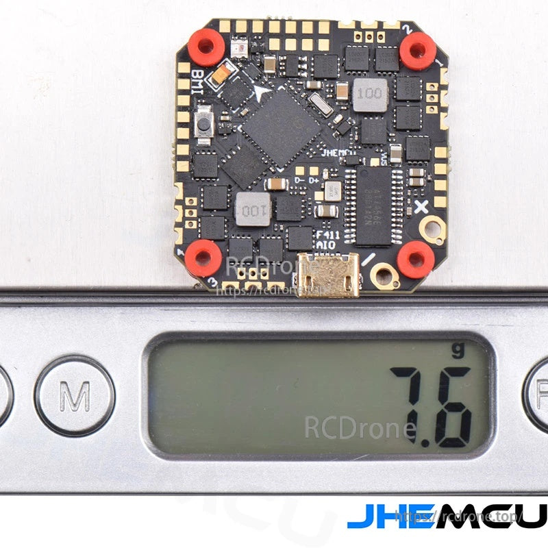 GHF411 AIO flight controller with vibration-damping grommets installed, weight shown as 7.6g