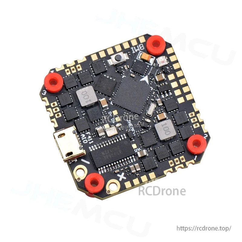 Angled close view of AIO flight controller board showing chips, solder pads, and USB connector