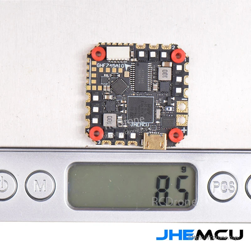 JHEMCU GHF745AIO-50A AIO flight controller on digital scale showing 8.5 g weight