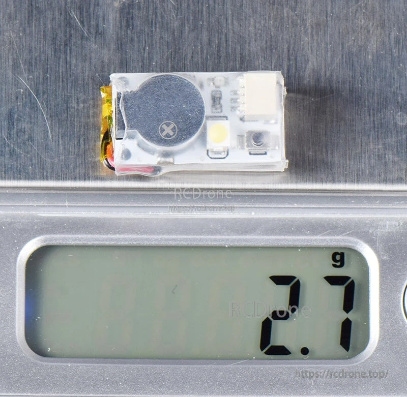 JHE20B Finder buzzer on a scale showing 2.7 g weight for lightweight FPV aircraft builds