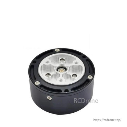Output side of motor reducer showing silver mounting plate, center shaft bore, and perimeter screw holes