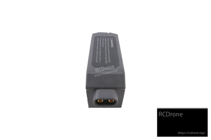Gray detachable battery module with warning label and two-pin power connector on the end