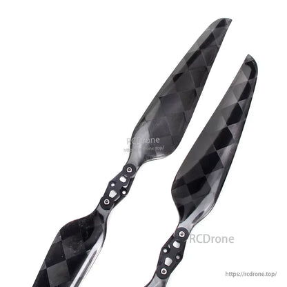 Glossy carbon fiber folding propeller blades with metal hub hardware, black checkered weave finish