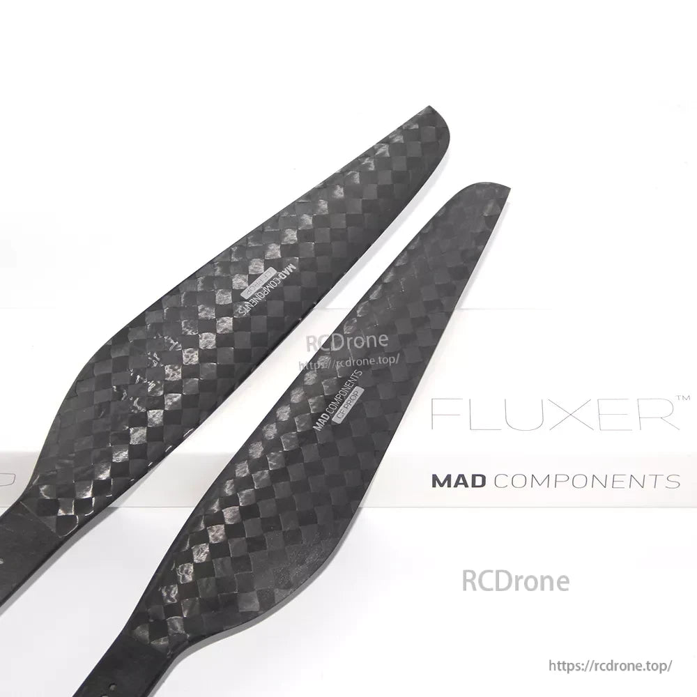 Pair of MAD FLUXER carbon fiber propeller blades with 28x8.4 sizing printed on the surface