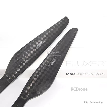 Pair of MAD FLUXER carbon fiber propeller blades with 28x8.4 sizing printed on the surface