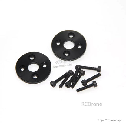 Black propeller mounting adapter plates with bolt holes and a set of hex screws for RC aircraft setup