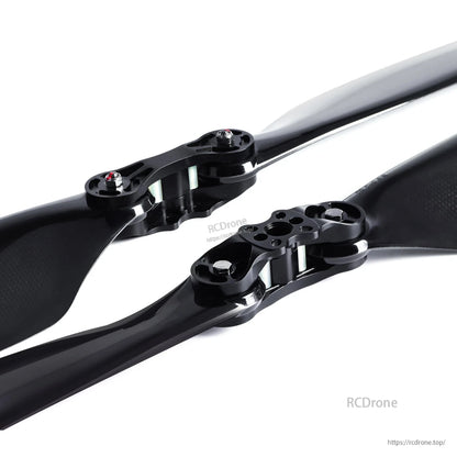 Glossy carbon fiber folding propeller with black hub and mounting bolts, MAD FLUXER Pro style