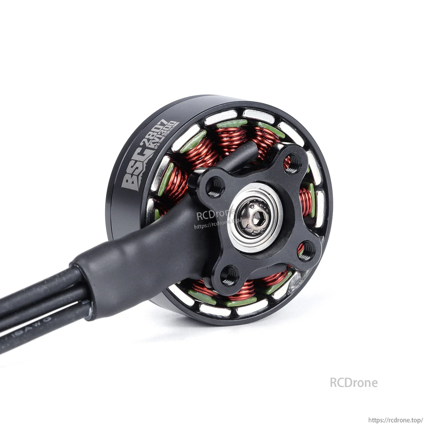 Close-up of MAD BSC2807 V1.0 FPV drone motor with exposed copper windings, mounting plate, and lead wires