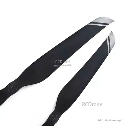 Pair of black carbon fiber paramotor propeller blades with gray tip stripes and M6 mounting holes