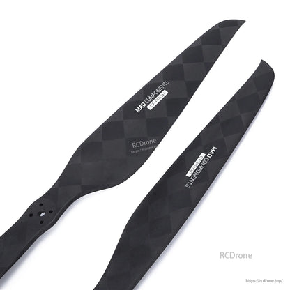 Pair of MAD Components carbon fiber drone propeller blades with checker weave finish and mounting holes