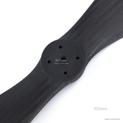 Two-blade carbon fiber eVTOL drone propeller with a multi-hole mounting hub and matte weave finish