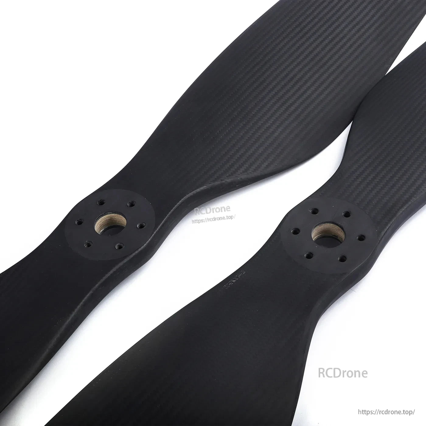Pair of MAD FLUXER CB2 64x20 carbon fiber propeller blades with matte weave finish and multi-hole hubs