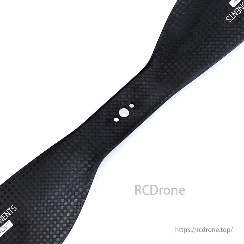A black carbon fiber propeller blade with textured surface, two circular markings, and "COMPONENTS" text is shown.