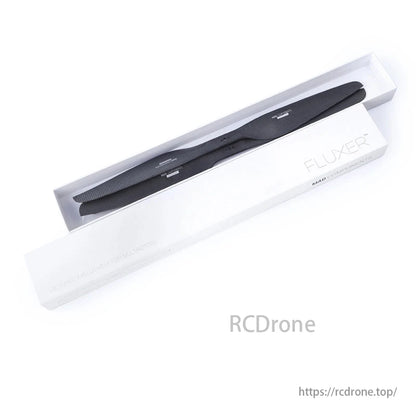 A black drone arm in a white "FLUXER" box by MAD COMPONENTS, for multicopters.