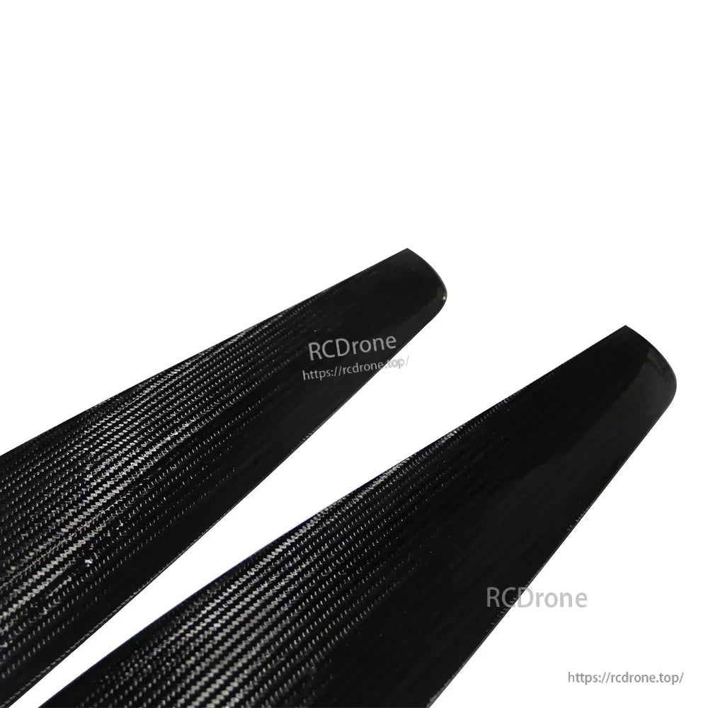 Close-up of MAD FLUXER PRO carbon fiber paramotor propeller blades with visible weave and rounded tips