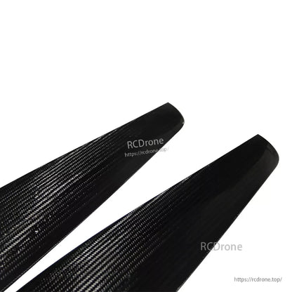 Close-up of MAD FLUXER PRO carbon fiber paramotor propeller blades with visible weave and rounded tips