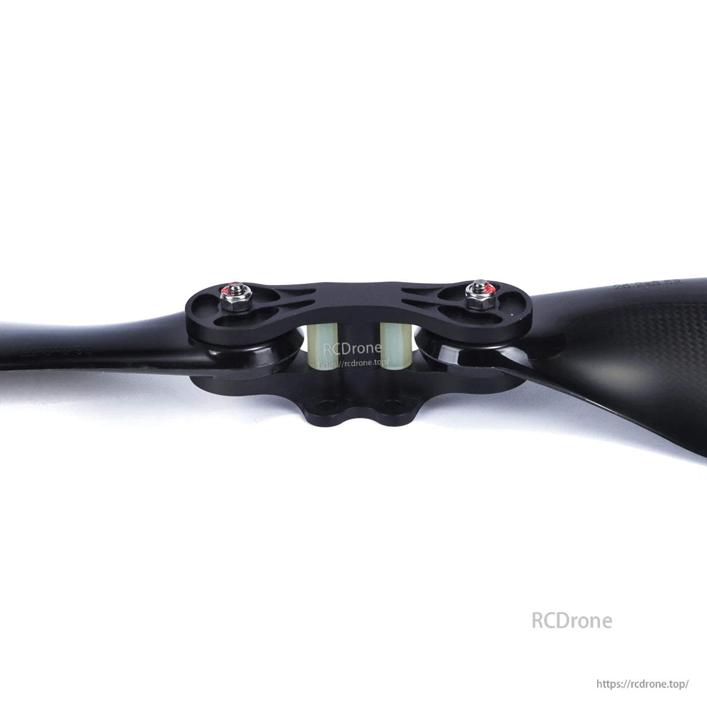 Close-up of MAD FLUXER Pro glossy carbon fiber folding propeller with central hub and mounting bolts